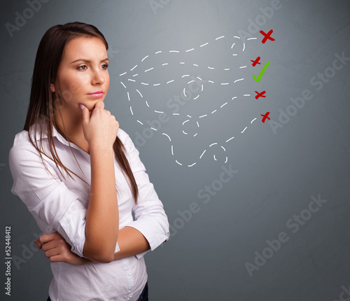 Photo: Young woman choosing between right and wrong signs Young woman choosing between right and wrong signs