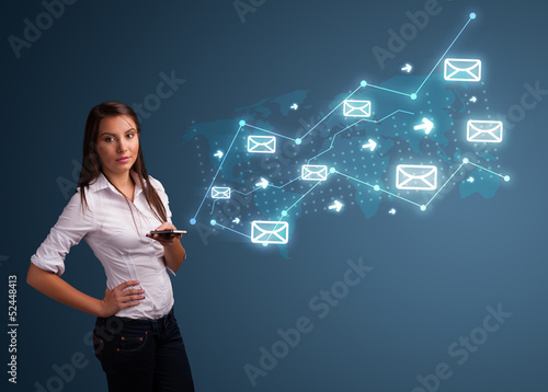 Photo: Young lady holding a phone with arrows and message icons Young lady holding a phone with arrows and message icons