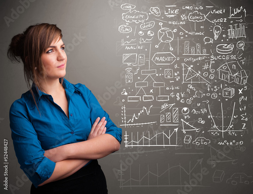 Photo: Pretty woman looking at stock market graphs and symbols Pretty woman looking at stock market graphs and symbols