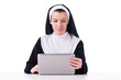 Nun working on laptop - religious concept