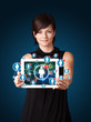 Photo: young woman holding tablet with social network icons young woman holding tablet with social network icons