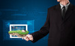 Foto: Businessman presenting a perfect ecology land with a house and w Businessman presenting a perfect ecology land with a house and w