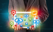 Businessman presenting modern tablet with colorful social signs