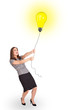 Happy woman holding a light bulb balloon