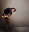 Young musician playing on saxophone