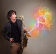 Attractive musician playing on saxophone with colorful abstract