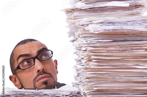 Photo: Busy businessman with lots of papers Busy businessman with lots of papers