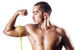 Photo : Muscular man measuring his muscles Muscular man measuring his muscles