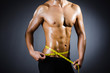 Muscular man measuring his muscles