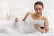 Young girl using  tablet on bed