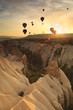 Hot air balloon over rock formations in Cappadocia, Turkey