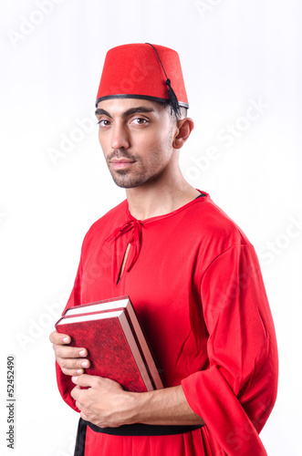 Photo: Young turk with book on white Young turk with book on white