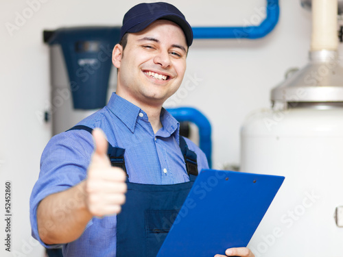 Photo: Young plumber at work Young plumber at work