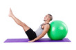 Man with swiss ball doing exercises on white