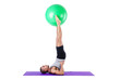 Man with swiss ball doing exercises on white