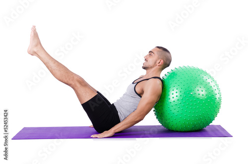 Photo: Man with swiss ball doing exercises on white Man with swiss ball doing exercises on white