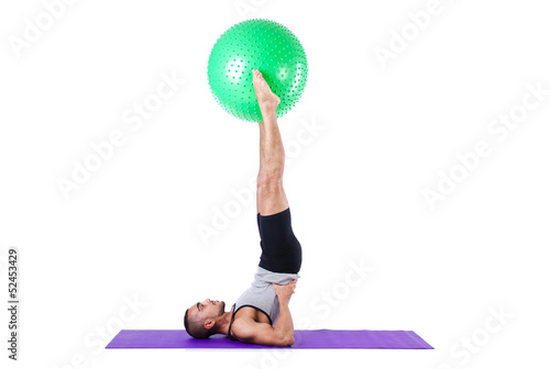 Photo: Man with swiss ball doing exercises on white Man with swiss ball doing exercises on white