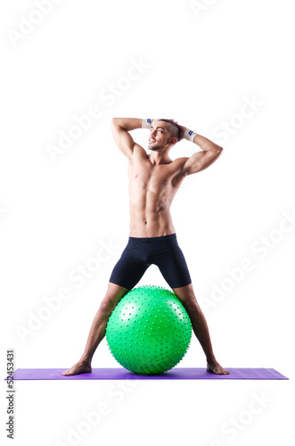 Photo: Man with swiss ball doing exercises on white Man with swiss ball doing exercises on white