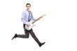Full length portrait of energetic young male jumping with a guit