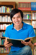 Student in library reading book