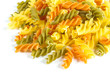 Uncooked pasta fusilli in different colours, white background
