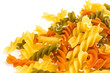 Uncooked pasta fusilli in different colours, white background