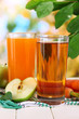 Glasses of juice, apples and carrots