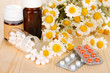 Medicine chamomile flowers on wooden table