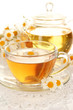 Cup of herbal tea with camomiles close up