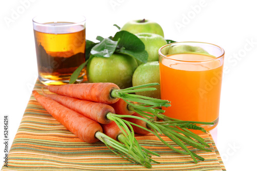 Photo: Glasses of juice, apples and carrots, isolated on white Glasses of juice, apples and carrots, isolated on white