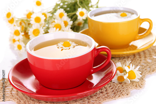 Photo: Cups of herbal tea with camomiles close up Cups of herbal tea with camomiles close up