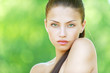 Portrait of young beautiful woman with bare shoulders