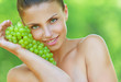 woman bites off from grape bunches