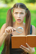 portrait serious beautiful woman magnifier book
