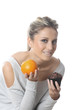 Model Released. Young Woman Holding an Orange and Cake