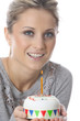 Model Released. Young Woman Holding Birthday Cake