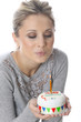 Model Released. Young Woman Holding Birthday Cake