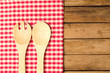 Background with wooden spoons over tablecloth