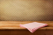 Empty wooden table with tablecloth over polka dots background