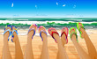 Female legs in colored flip flops against the sunny beach