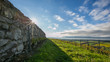 Photo: Sun rising over a stone wall Sun rising over a stone wall