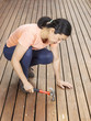 Mature woman working on Deck with Hammer