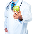 Doctor's hand holding a fresh green apple close-up
