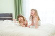 Photo: Two little girls lying on bed Two little girls lying on bed