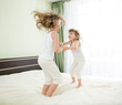 Photo: Little girls jumping on bed Little girls jumping on bed