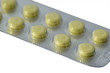 Yellow pills in blister isolated on white background