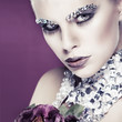 sexual beautiful girl with strasses on face, on a violet 