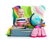 Photo: Baby girl sitting in suitcase with things for vacation travel Baby girl sitting in suitcase with things for vacation travel