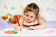child writing with felt-tip pen