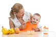 mother spoon feeding baby boy